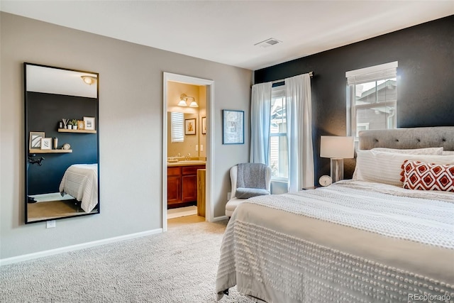 carpeted bedroom featuring connected bathroom