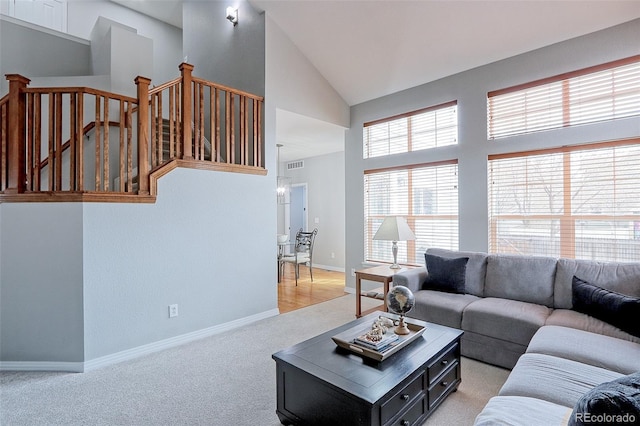 14214 Lakeview Ln, Broomfield, CO 80023 - living area featuring light carpet, baseboards, and high vaulted ceiling