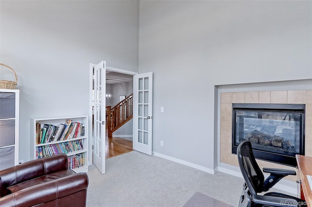 14214 Lakeview Ln, Broomfield, CO 80023 - office with french doors, carpet floors, a towering ceiling, a tile fireplace, and baseboards