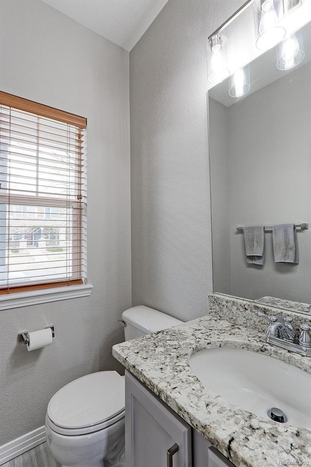 14214 Lakeview Ln, Broomfield, CO 80023 - half bathroom featuring toilet, vanity, and baseboards