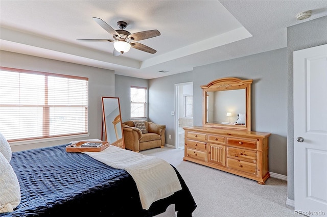 14214 Lakeview Ln, Broomfield, CO 80023 - bedroom featuring light carpet, a raised ceiling, a ceiling fan, baseboards, and ensuite bathroom