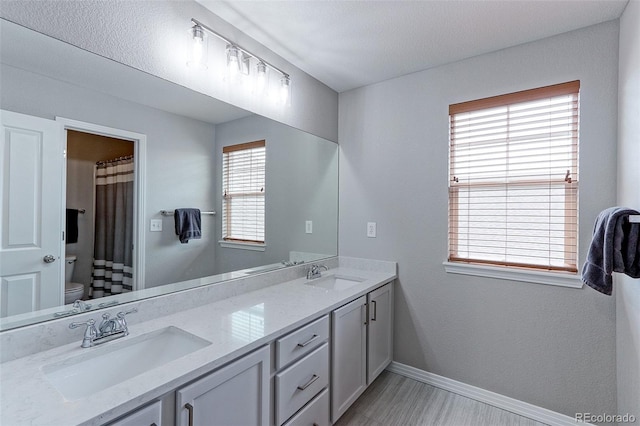 14214 Lakeview Ln, Broomfield, CO 80023 - bathroom with baseboards, toilet, double vanity, and a shower with shower curtain