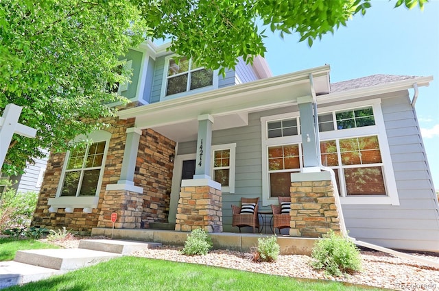 14214 Lakeview Ln, Broomfield, CO 80023 - view of front facade with a porch and stone siding