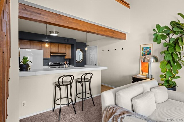 kitchen with a kitchen breakfast bar, stainless steel electric range, fridge, range hood, and beamed ceiling