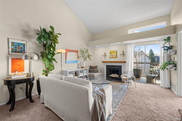 living area with carpet, a fireplace, high vaulted ceiling, and baseboards