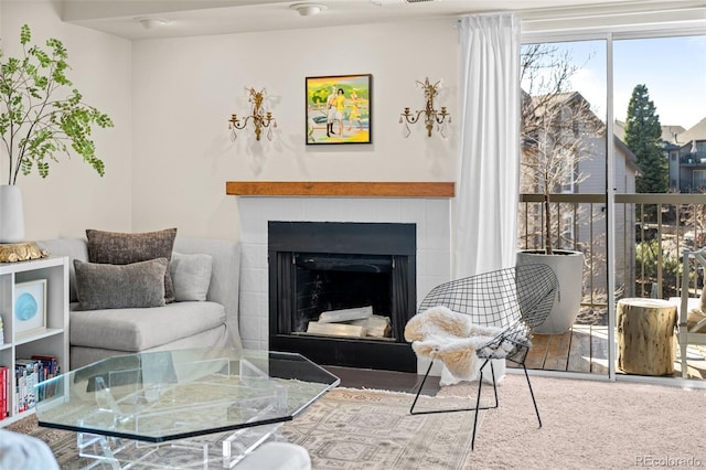 living area featuring a fireplace and visible vents