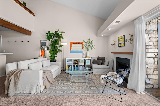 carpeted living area with a fireplace and visible vents