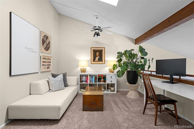 carpeted office space with a ceiling fan, vaulted ceiling with beams, a textured ceiling, and baseboards