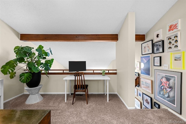 office space with carpet, beam ceiling, and baseboards