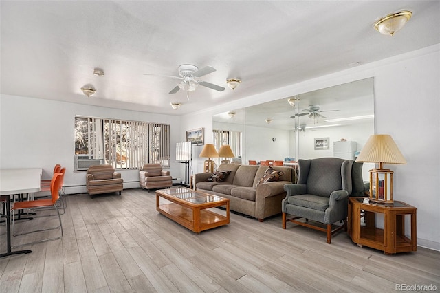 living room with a baseboard heating unit, ceiling fan, and light wood finished floors