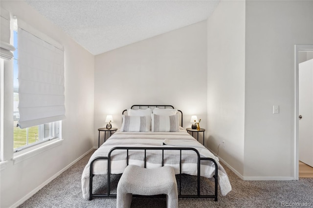 bedroom with carpet flooring, baseboards, and vaulted ceiling
