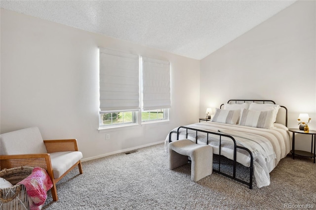 carpeted bedroom with a textured ceiling, lofted ceiling, and baseboards