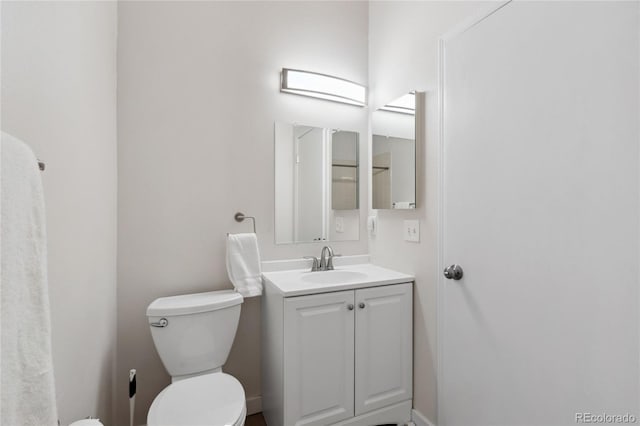 bathroom featuring toilet and vanity