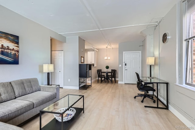 444 17th St Unit 701, Denver, CO 80202 - living room featuring light wood-type flooring, baseboards, and a chandelier