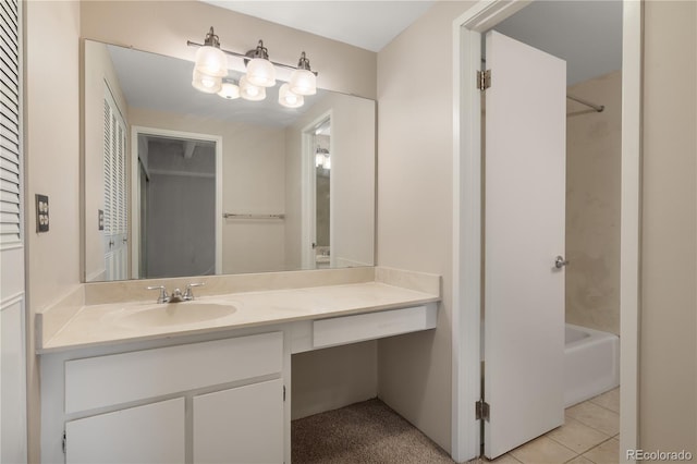 bathroom featuring a tub to relax in, vanity, and tile patterned floors