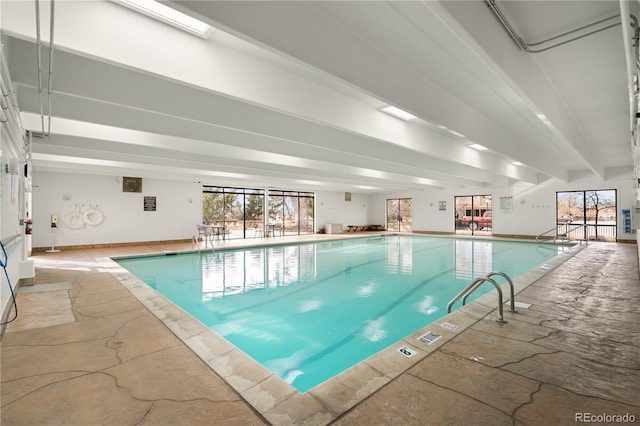 view of swimming pool featuring a skylight