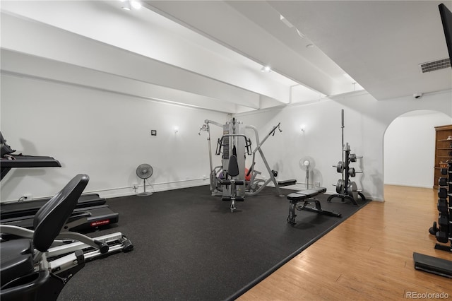 exercise room with hardwood / wood-style flooring