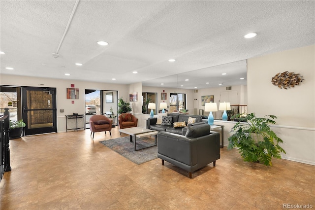 living room featuring plenty of natural light and a textured ceiling