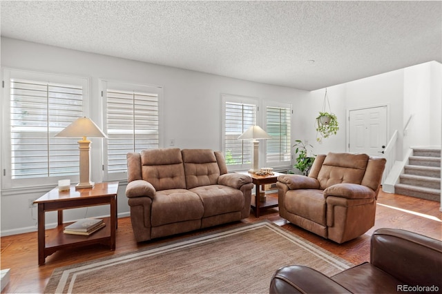 2181 E Phillips Ln, Centennial, CO 80122 - living area featuring wood finished floors, a textured ceiling, and stairs