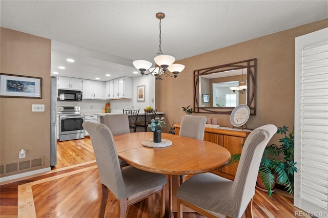 2181 E Phillips Ln, Centennial, CO 80122 - dining area with a chandelier, light wood-type flooring, and recessed lighting