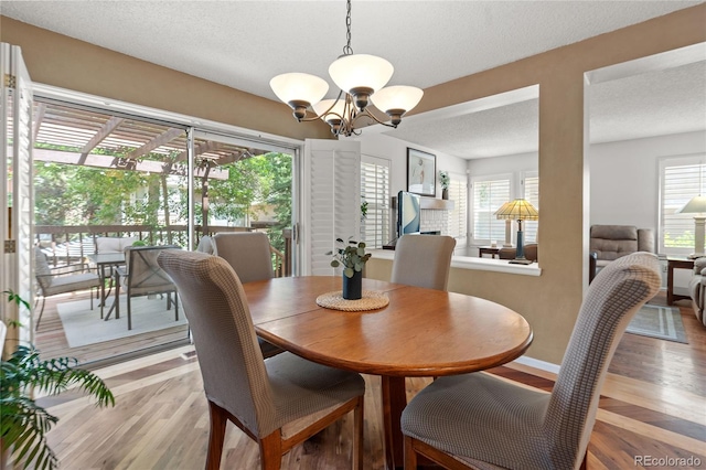 2181 E Phillips Ln, Centennial, CO 80122 - dining room with a textured ceiling, a chandelier, and light wood-style floors