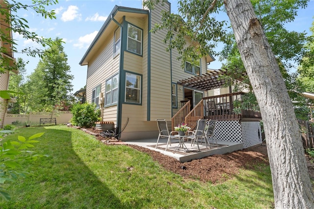 2181 E Phillips Ln, Centennial, CO 80122 - back of property featuring a pergola, a patio area, a deck, and a chimney