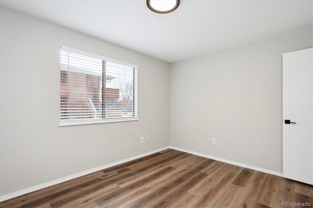 unfurnished room with dark hardwood / wood-style floors