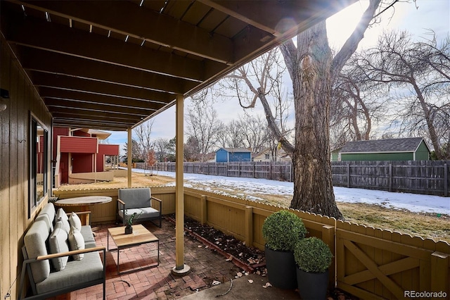 snow covered patio featuring a hot tub