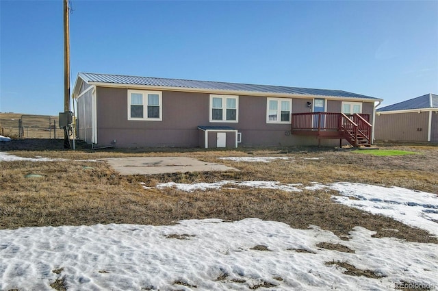 snow covered property featuring a deck