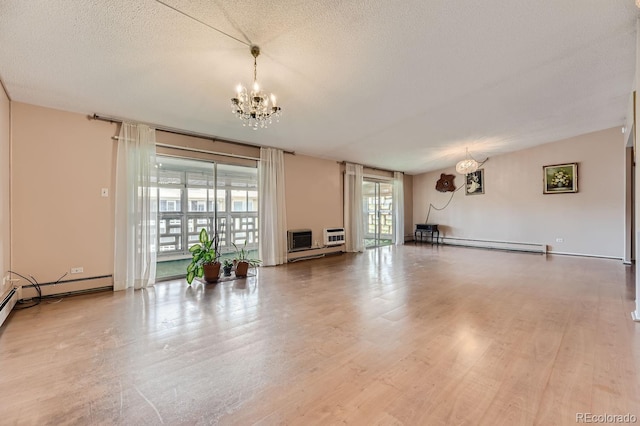 unfurnished living room with an inviting chandelier, wood-type flooring, a textured ceiling, and a baseboard heating unit