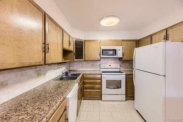 kitchen with white appliances, sink, decorative backsplash, light tile patterned floors, and light stone counters