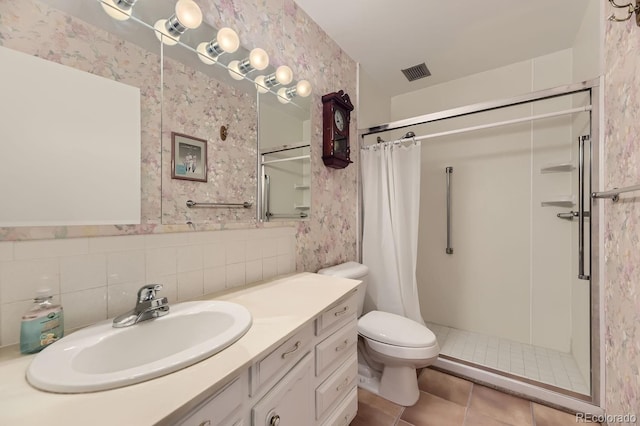 bathroom with tile patterned flooring, a shower with curtain, toilet, and vanity