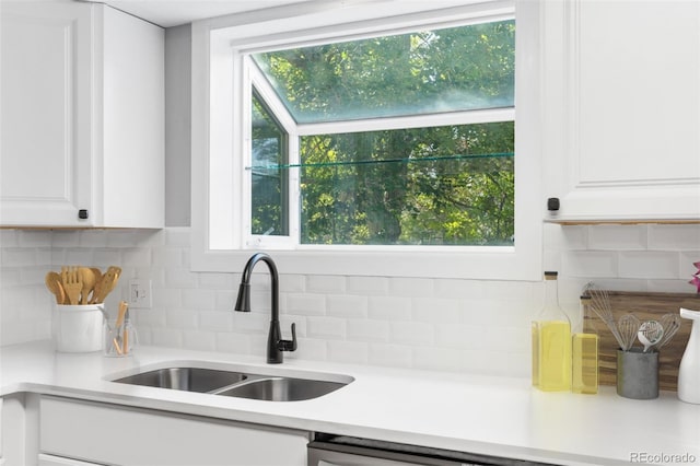 kitchen featuring white cabinets, tasteful backsplash, and sink