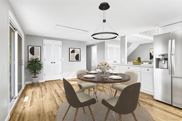 dining space with light wood-type flooring