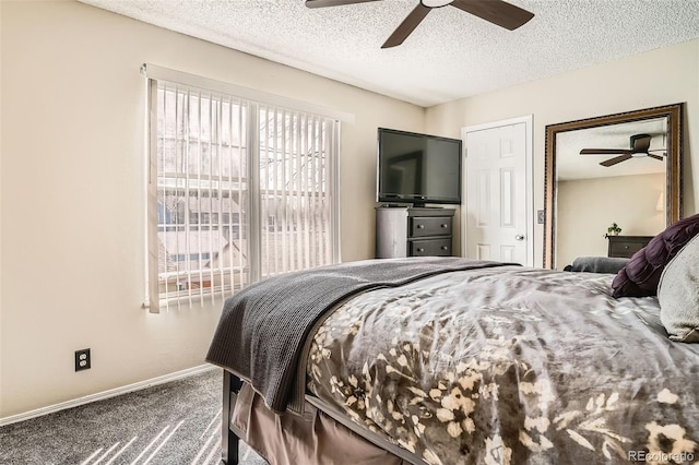 carpeted bedroom featuring a textured ceiling, baseboards, and a ceiling fan