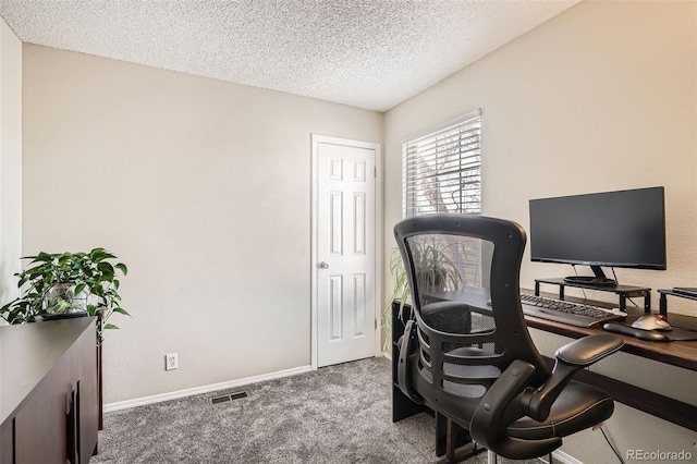 office with visible vents, baseboards, a textured ceiling, and carpet flooring