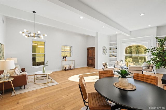 dining room with a chandelier, built in shelves, light hardwood / wood-style flooring, and beamed ceiling