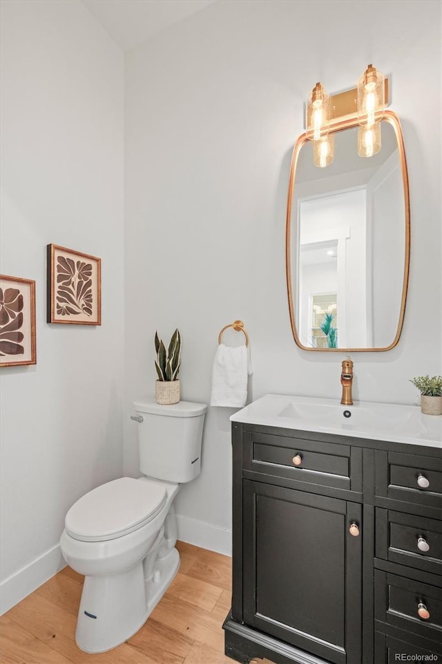 bathroom featuring hardwood / wood-style floors, toilet, and vanity