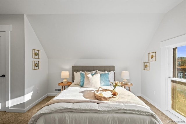 bedroom featuring lofted ceiling and carpet