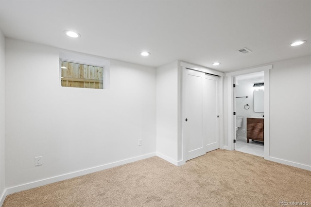 unfurnished bedroom with light carpet and a closet