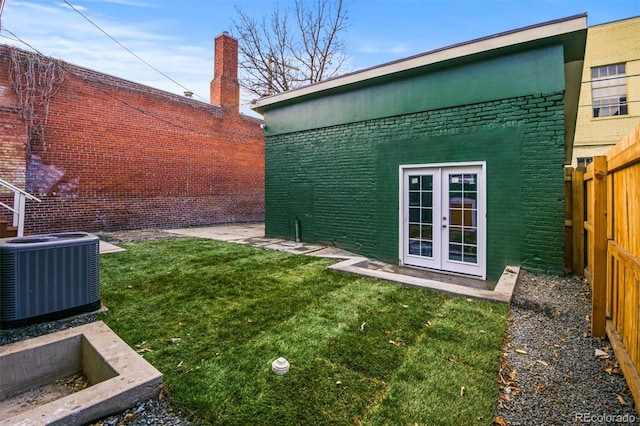 view of yard with cooling unit and french doors