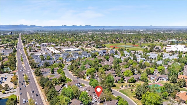 aerial overview of property's location featuring a mountain backdrop, nearby suburban area, and a major roadway
