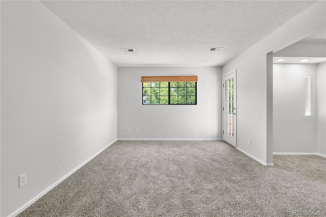 unfurnished room featuring carpet floors, a textured ceiling, and baseboards