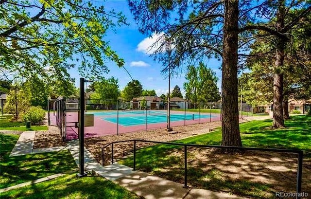 view of swimming pool featuring a tennis court