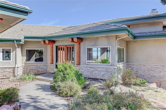 4440 Monitor Rock Ln, Colorado Springs, CO 80904 - entrance to property featuring a tiled roof, stone siding, and stucco siding
