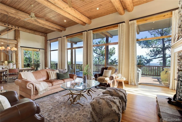 living area featuring a wealth of natural light, wooden ceiling, and wood finished floors