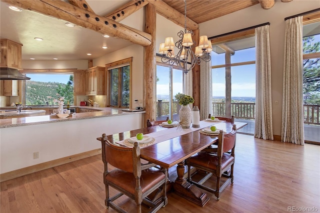 dining space with vaulted ceiling with beams, baseboards, recessed lighting, light wood-style flooring, and an inviting chandelier