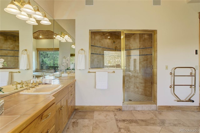 full bath featuring baseboards, a stall shower, and vanity