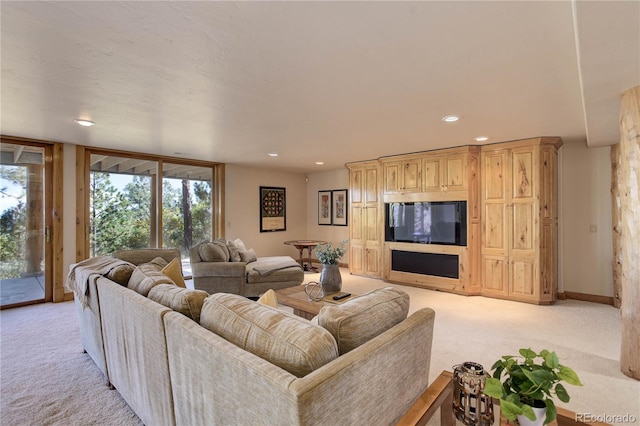 living room featuring a wealth of natural light, recessed lighting, and light colored carpet