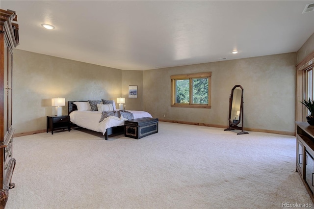 bedroom with light carpet, visible vents, and baseboards